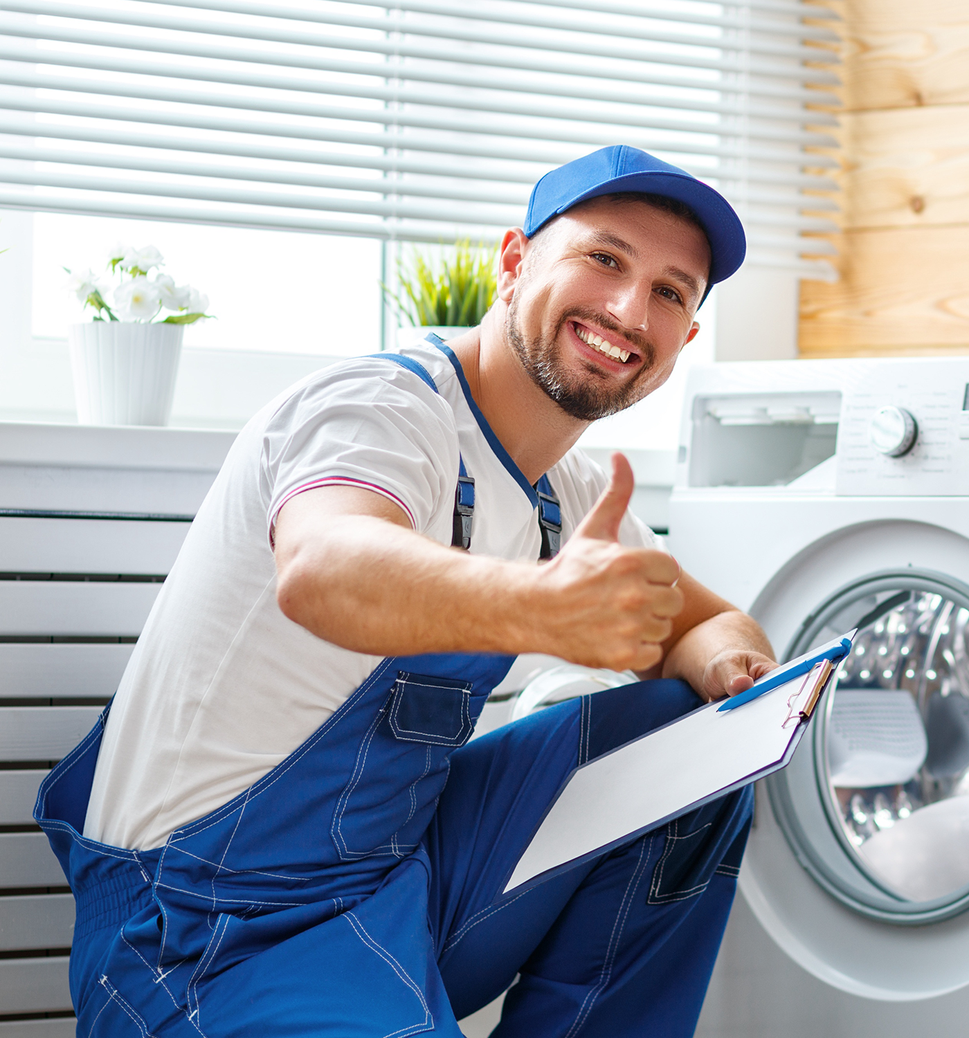 Technician posing next to washer