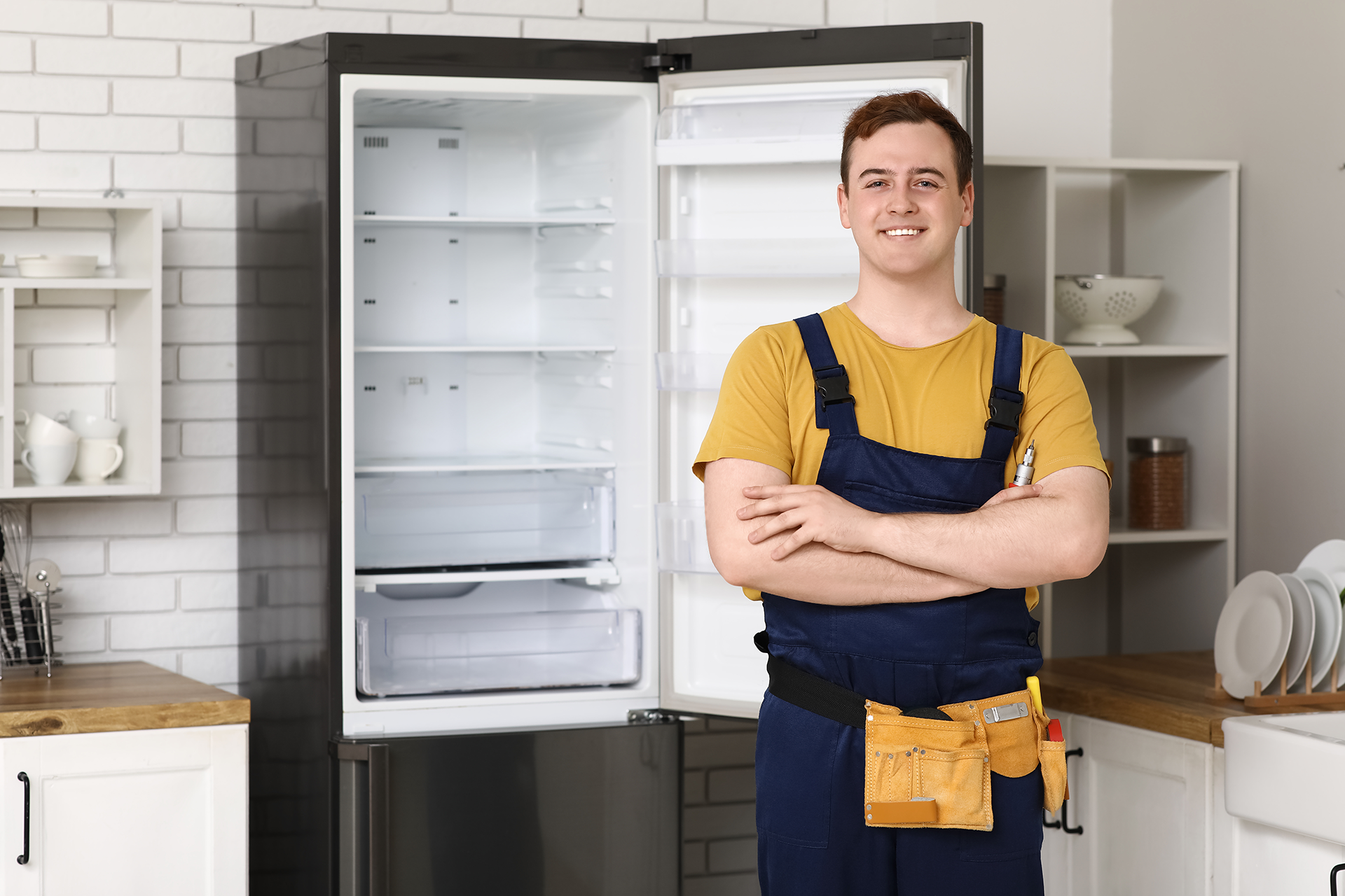 Technician repairing refrigerator