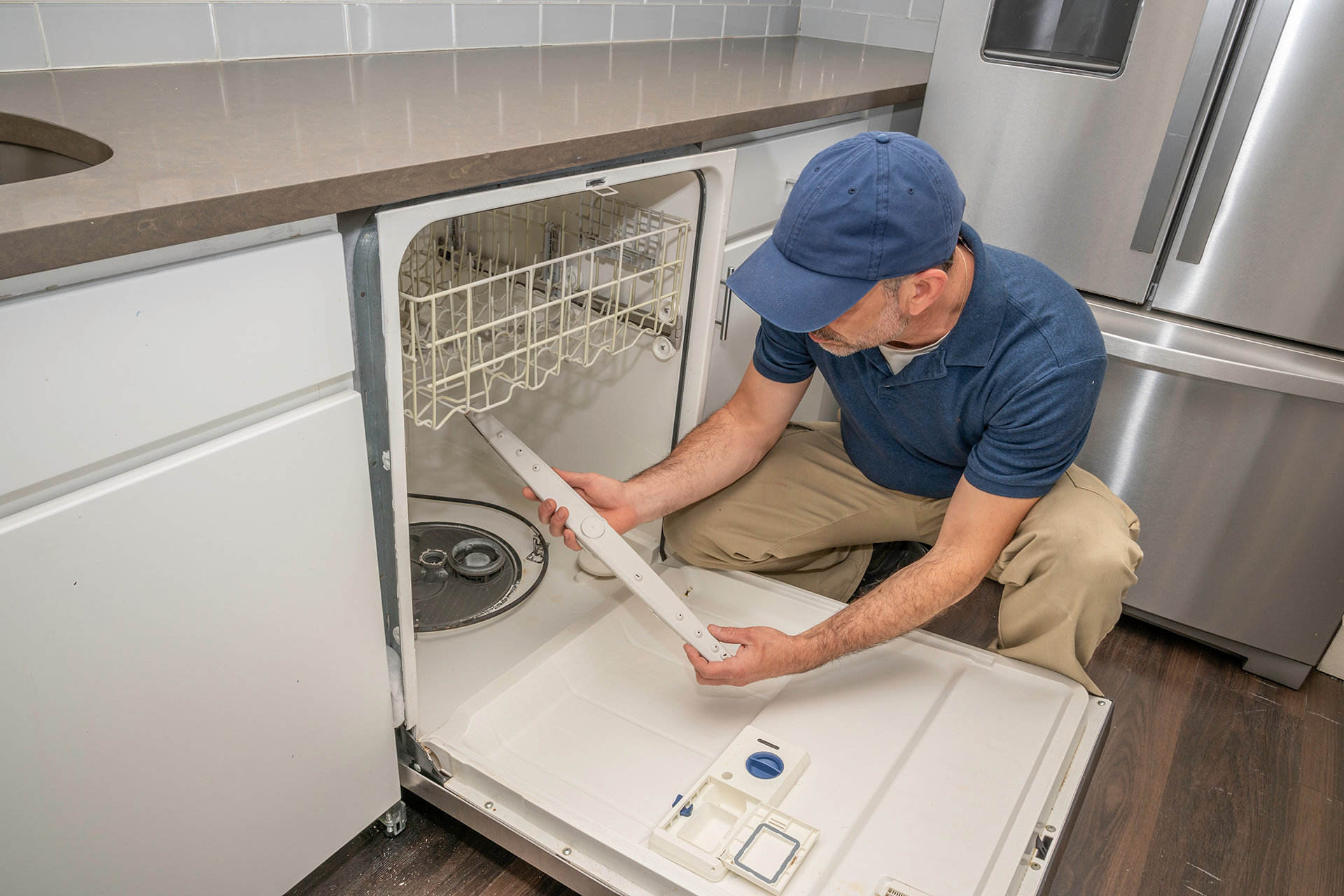 Technician repairing dishwasher